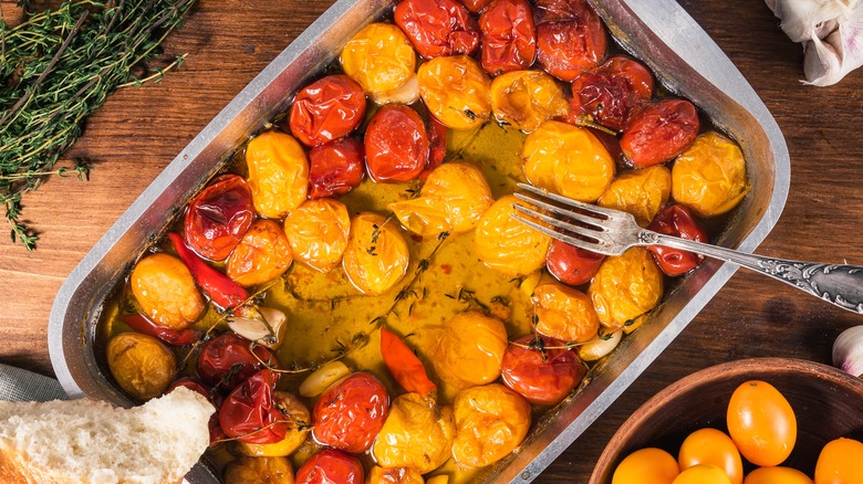 Cherry tomatoes cooked confit in a pan