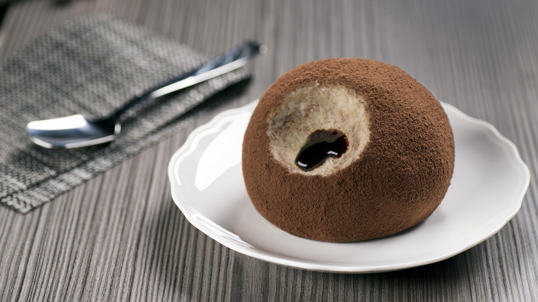 Large ice cream truffle filled with chocolate on a plate