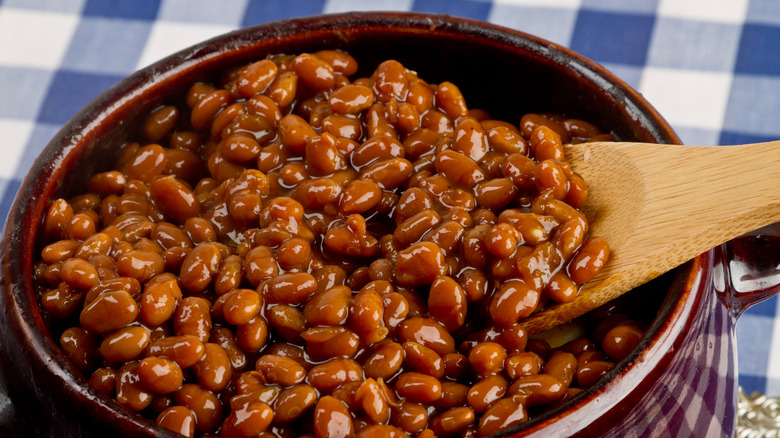 bowl of baked beans with wooden spoon