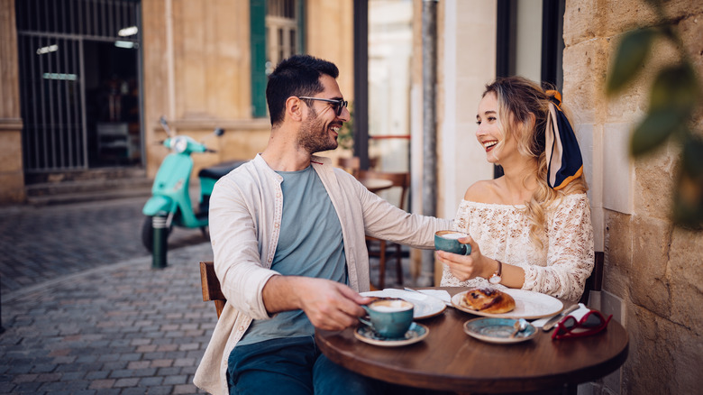 couple enjoying coffee at Italian café