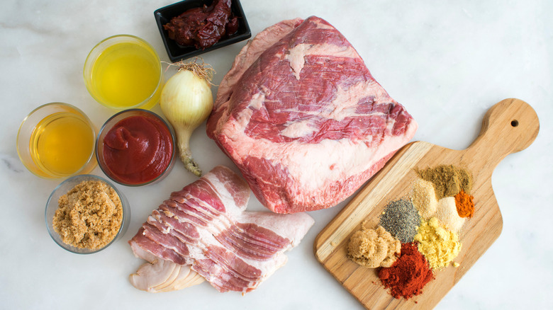 raw brisket next to sauce ingredients