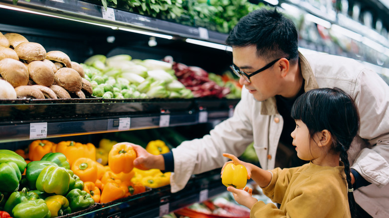 people grocery shopping for vegetables