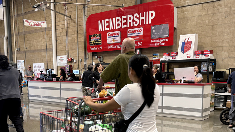 Shoppers file past the Membership desk in a Costco Wholesale