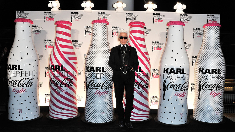 Karl Lagerfeld in front of Diet Coke display