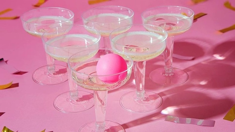 pink ping pong ball in glass of sparkling wine