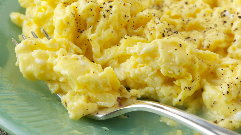 Scrambled eggs with large curds with fork