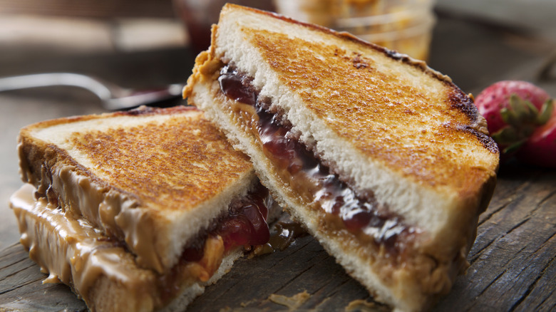 grilled peanut butter and jelly sandwich cut in half diagonally with one side stacked on the other