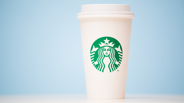 Starbucks hot to-go cup on blue background