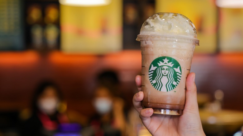 hand holding up starbucks frappuccino