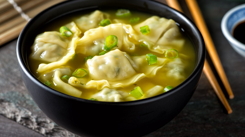 Bowl of wonton soup with chives