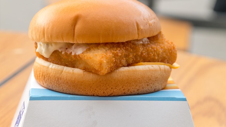 Filet O Fish sandwich on top of its box