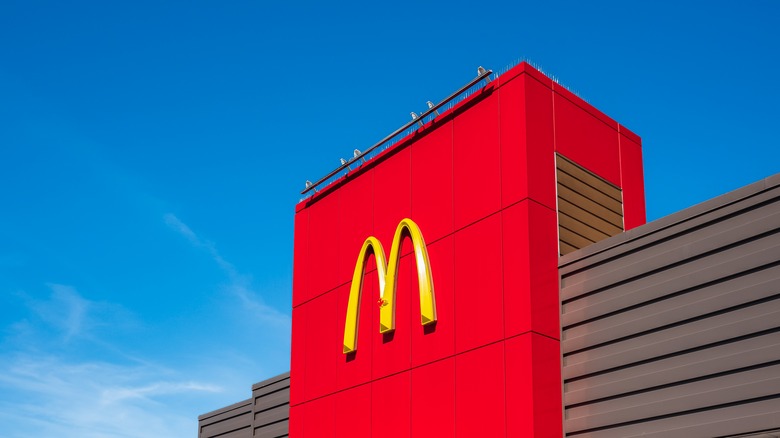 building with McDonald's logo against a blue sky