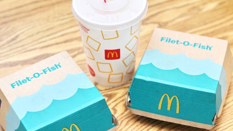 two Filet O Fish boxes with soft drink cup