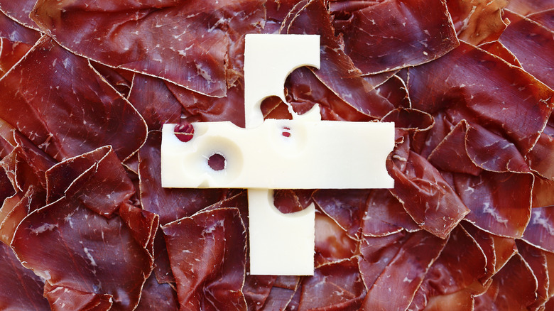 Swiss flag depicted with swiss cured meat and cheese