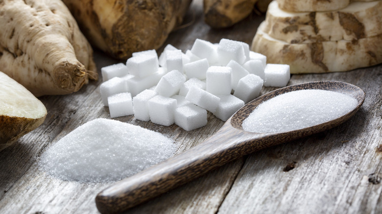 white sugar cubes and granulated piles