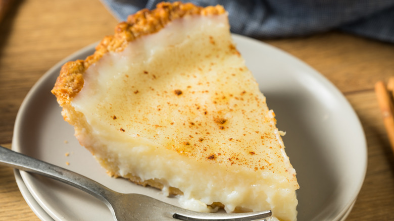 Slice of homemade sugar cream pie sprinkled with cinnamon