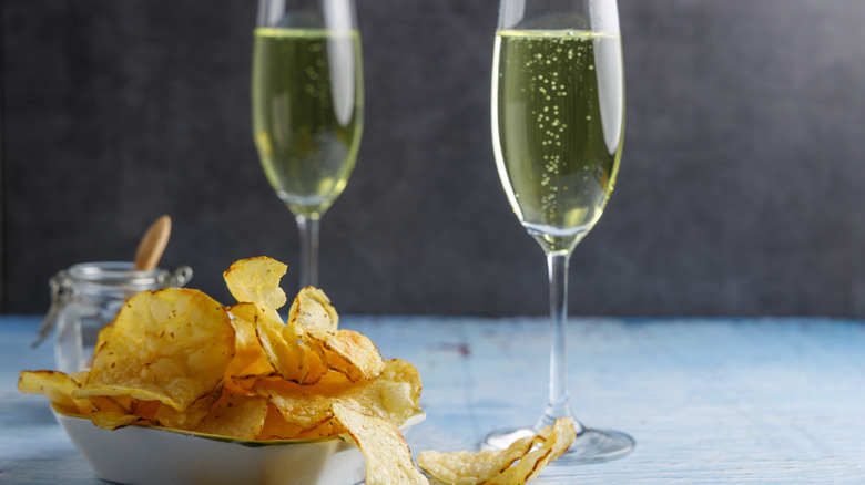 Potato chips and glasses of champagne