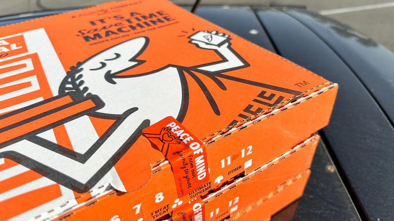 A stack of Little Caesars pizza boxes