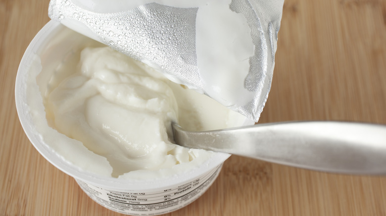 container of greek yogurt with spoon