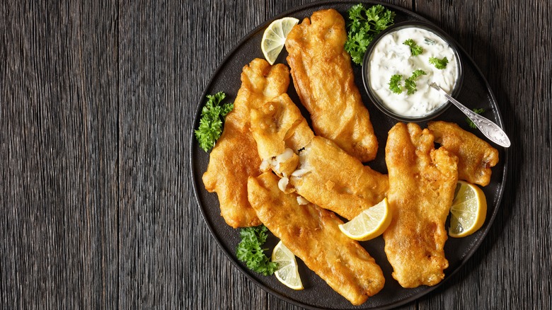 Fried fish fillets, lemon wedges, and tartar sauce