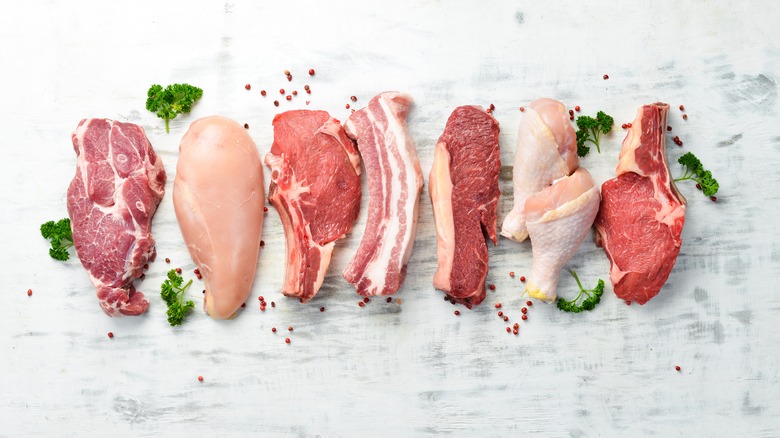 Various meats lined up on a white surface 