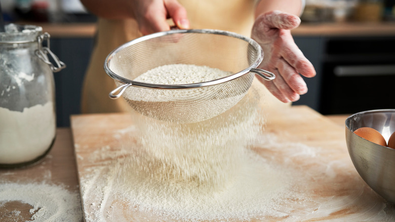 Person sifting flour
