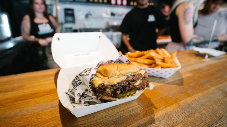 NADC burger and fries on a wooden counter