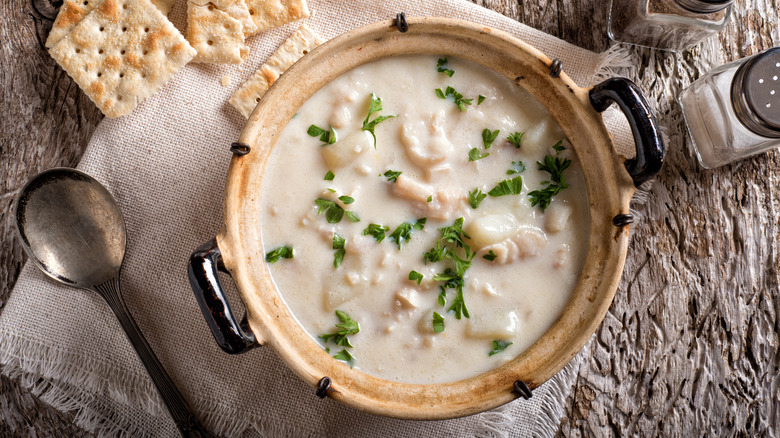 bowl of new england clam chowder with crackers