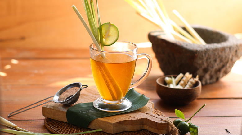 Cup of hot lemongrass tea on wooden board