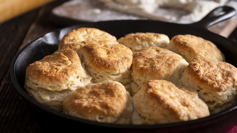 Fresh biscuits are nestled together in a heavy cast iron pan