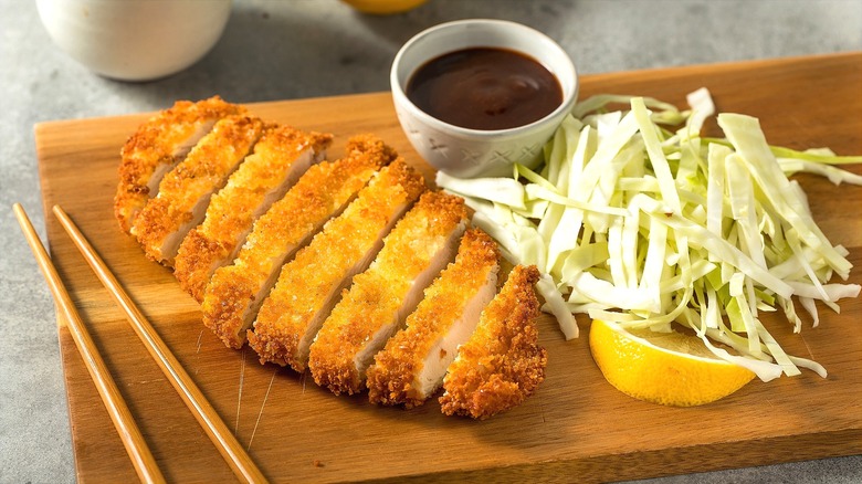 Sliced chicken katsu on cutting board