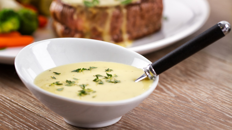 Bearnaise sauce in bowl with spoon