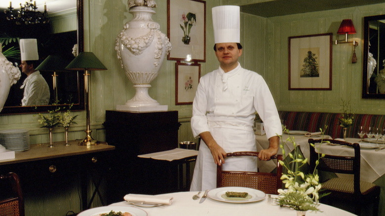 A young Joël Robuchon at a table in a restaurant