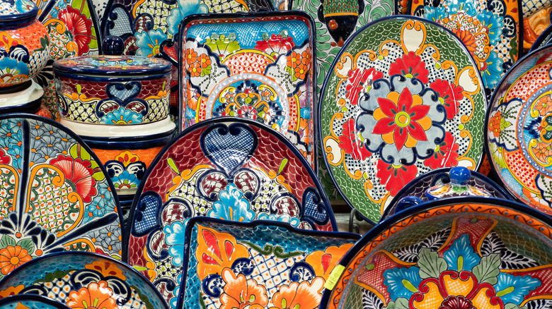 Colorful traditional Mexican terra cotta pottery serveware plates and trays