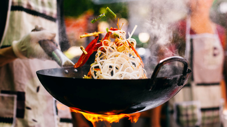 Stir frying vegetables in a wok