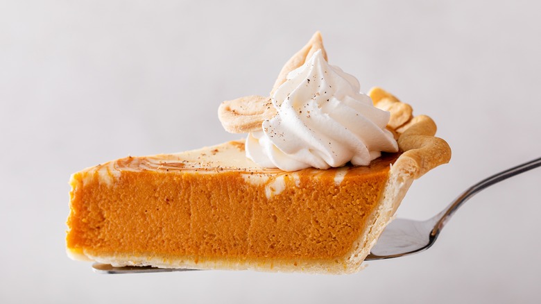 slice of pumpkin pie with whipped cream