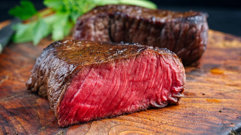 Rare steak on wooden cutting board