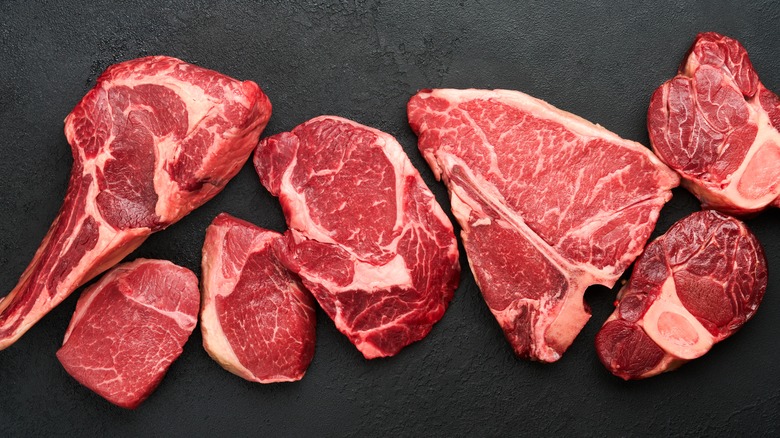 Raw steaks on slate board
