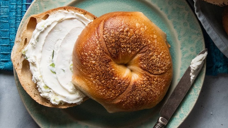 Bagel with cream cheese and butter knife