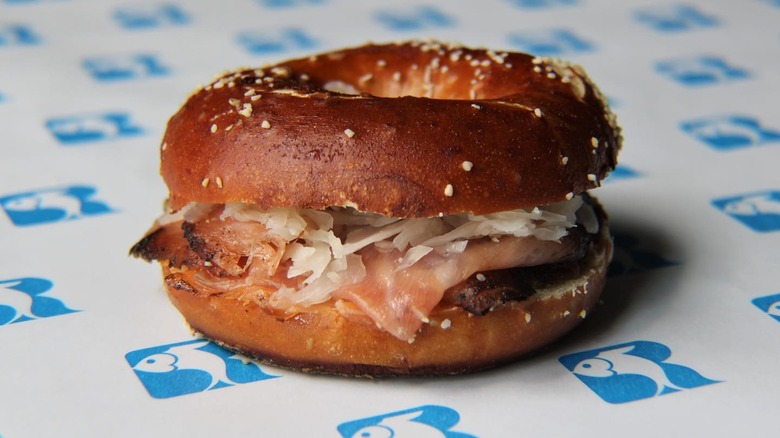 Bagel sandwich on blue and white paper