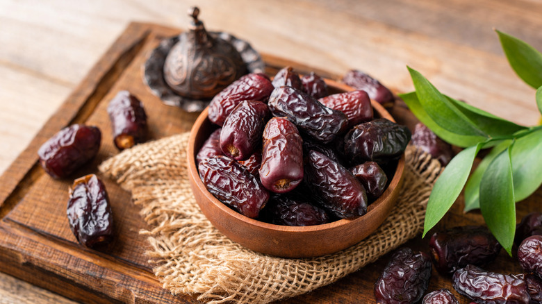 Dried dates in a wooden bowl