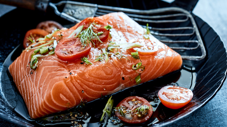 Skillet with salmon and fish spatula