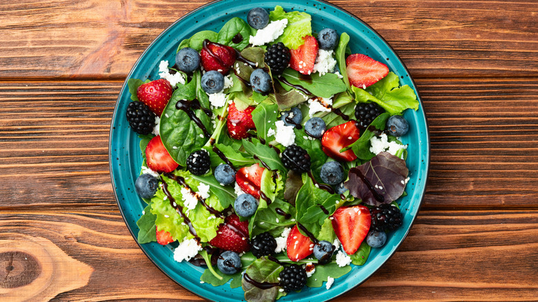 feta and blueberry salad on a wooden background