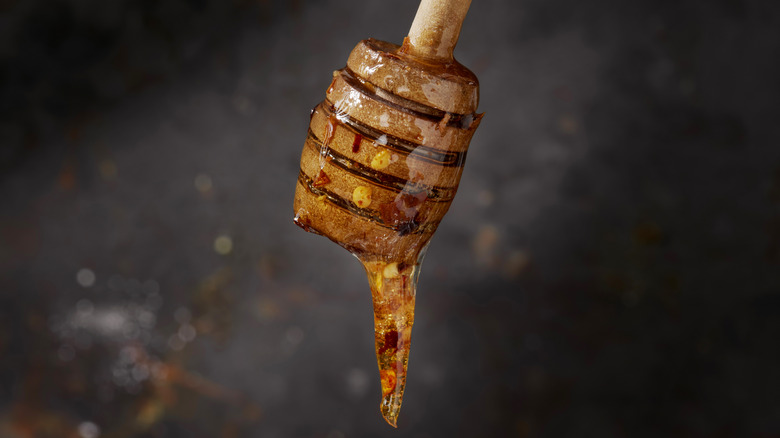 Honey dripping off of a honey dipper