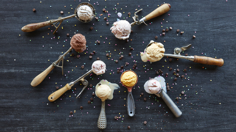 Filled ice cream scoops on a table surrounded by chocolate chips