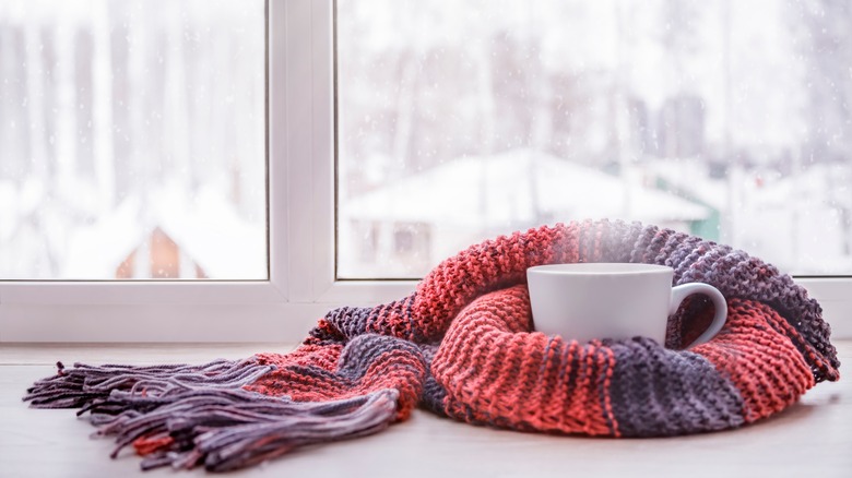 Cup of coffee against snowy backdrop