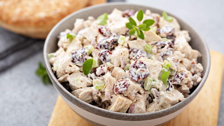 A scoop of creamy chicken sits on a bed of lettuce