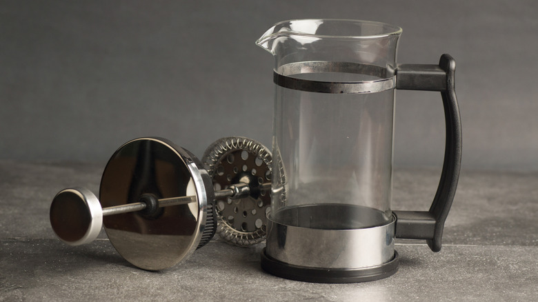 An empty French press with its lid removed