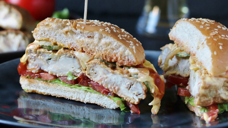 Close up of a fried brain sandwich from Hilltop Inn on a plate with pickles and onions