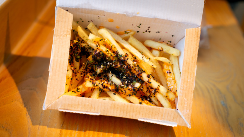 Furikake fries in a box on a wooden table